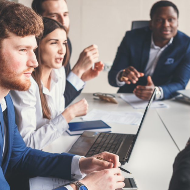 A busy conference room filled with professionals working on a key project.