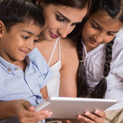 A young family using a tablet to browse various housing services.